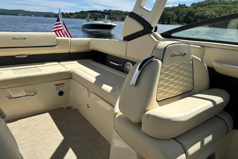 Slide: The Image of Luxurious interior of 2026 Chris-Craft Sportster 28 boat with elegant seating and lake view. - 28