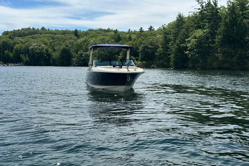 Slide: The Image of 2026 Chris-Craft Sportster 28 on a serene lake with lush green forest backdrop. - 4