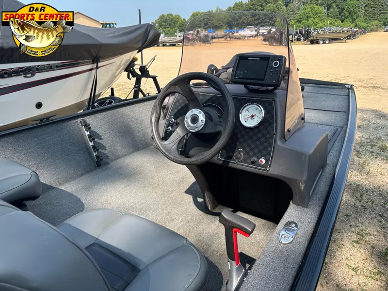 Slide: The Image of 2021 Tracker Bass Tracker Classic XL boat interior with steering wheel and control panel. - 7