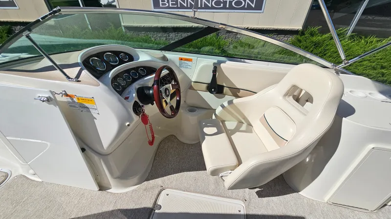 Slide: The Image of 2000 Chris-Craft 262 Sport Deck boat interior with steering wheel and captain's seat. - 10