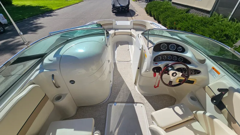 Slide: The Image of 2000 Chris-Craft 262 Sport Deck boat interior with steering wheel and dashboard controls. - 12