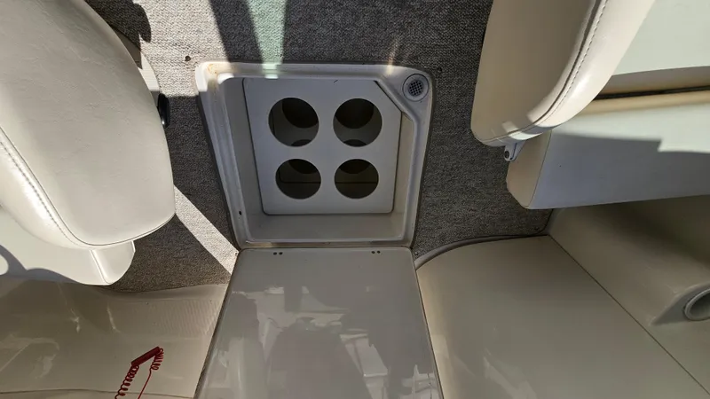 Slide: The Image of Interior of a 2000 Chris-Craft 262 Sport Deck boat with cup holders. - 18