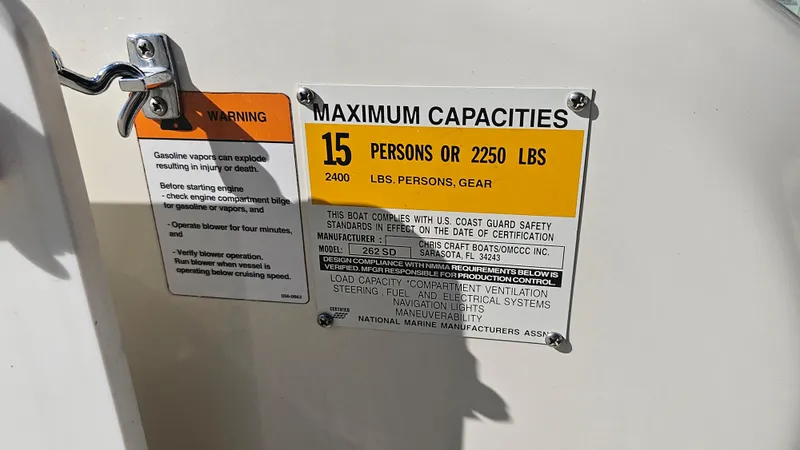 Slide: The Image of Chris-Craft 262 Sport Deck 2000 capacity warning label, 15 persons or 2250 lbs limit. - 21