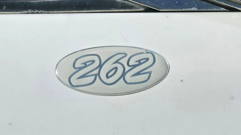 Slide: The Image of Chris-Craft 262 Sport Deck 2000 model emblem on white surface. - 22