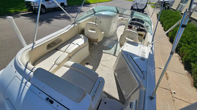 Slide: The Image of 2000 Chris-Craft 262 Sport Deck boat interior with seating and steering console. - 6