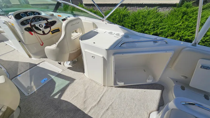 Slide: The Image of Interior of 2000 Chris-Craft 262 Sport Deck boat with steering wheel and seating. - 9