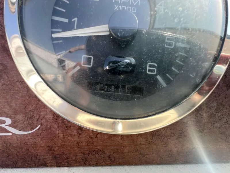 Slide: The Image of 1997 Sea Ray 270 Sundancer helm with steering wheel and control panel. - 10