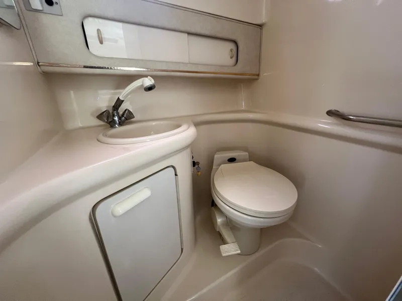 Slide: The Image of 1997 Sea Ray 270 Sundancer electrical panel with control switches and warning label. - 18