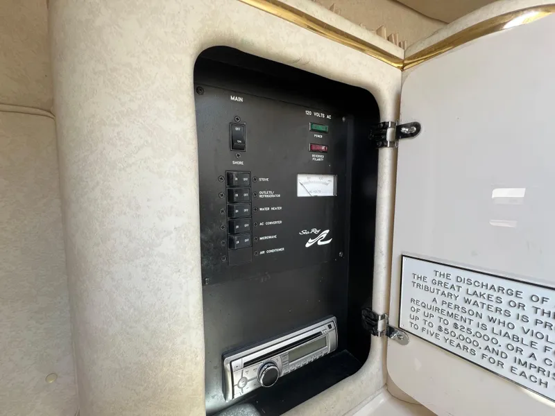 Slide: The Image of 1997 Sea Ray 270 Sundancer cabin interior with beige upholstery and window. - 19