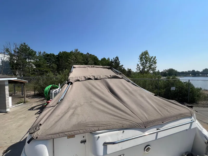 Slide: The Image of Open storage compartment on 1997 Sea Ray 270 Sundancer boat with ropes inside. - 24