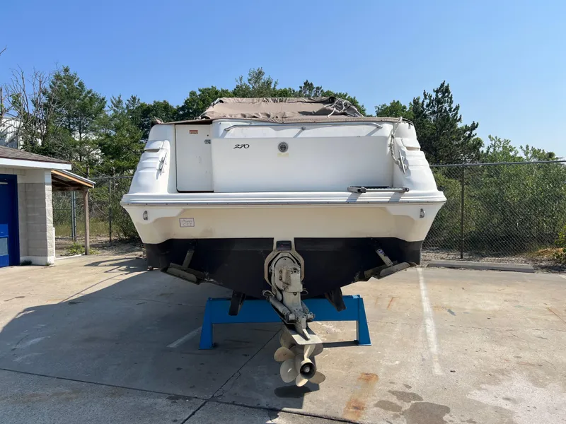 Slide: The Image of Interior of 1997 Sea Ray 270 Sundancer boat with kitchenette and seating area. - 3
