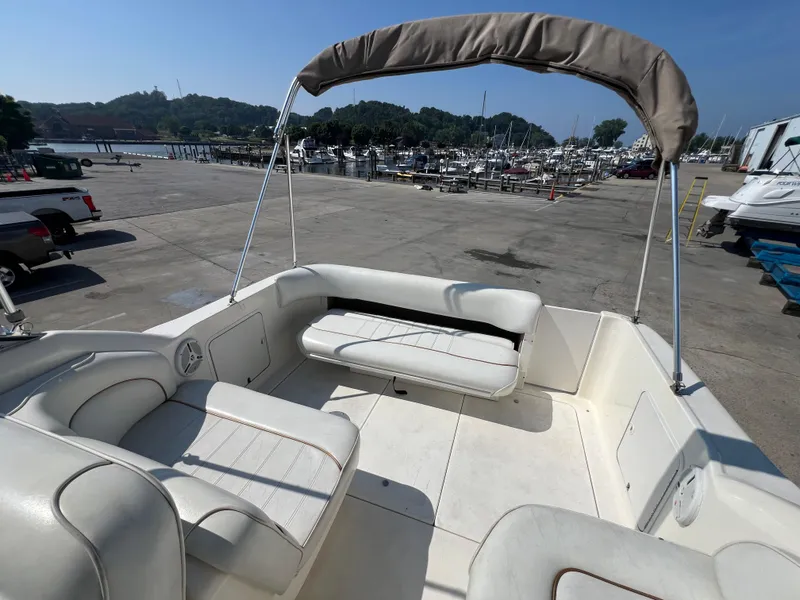 Slide: The Image of 1997 Sea Ray 270 Sundancer boat on a trailer, parked outdoors. - 6