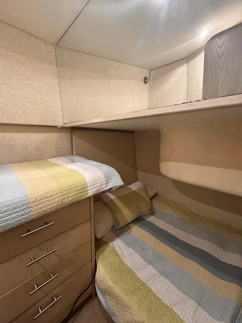 Slide: The Image of Cozy cabin interior of 1997 Ocean Yachts 45 Super Sport with striped bedding. - 4