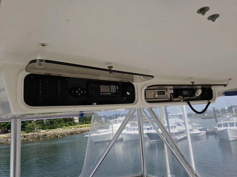 Slide: The Image of 1997 Ocean Yachts 45 Super Sport helm electronics with marina view in background. - 3