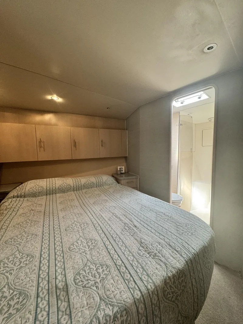 Slide: The Image of Bedroom interior of 1997 Ocean Yachts 45 Super Sport with bed and ensuite bathroom. - 8