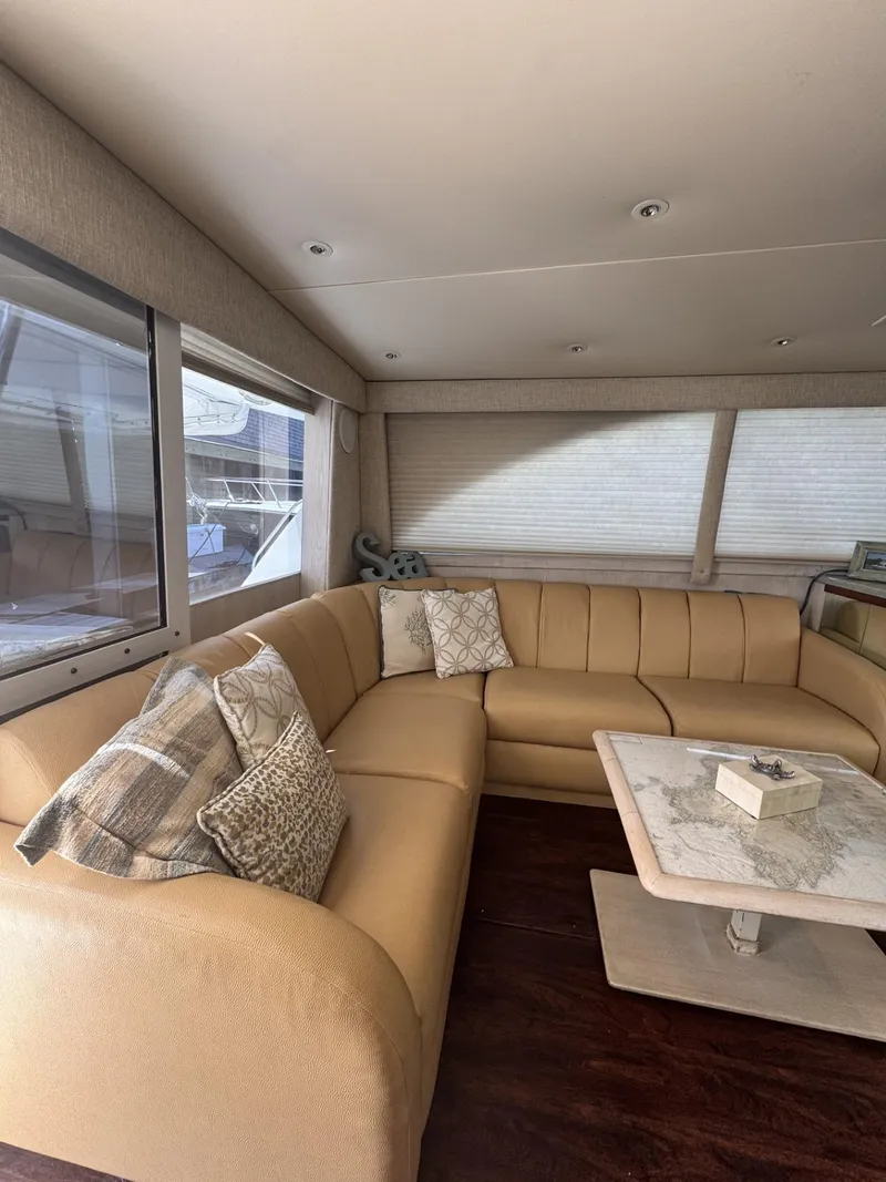 Slide: The Image of Luxurious interior of a 1997 Ocean Yachts 45 Super Sport with beige seating and decorative pillows. - 9