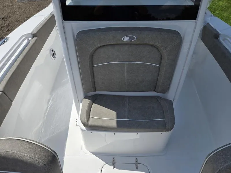 Slide: The Image of 2026 Sea Hunt Ultra 275se boat seating area with gray cushioned seat and sleek design. - 11