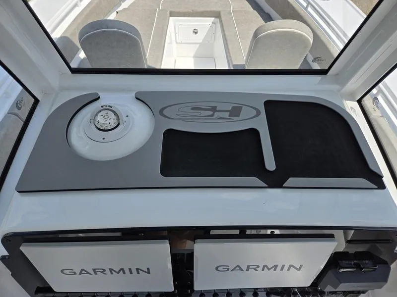 Slide: The Image of 2026 Sea Hunt Ultra 275se dashboard with Garmin electronics and SH logo. - 13
