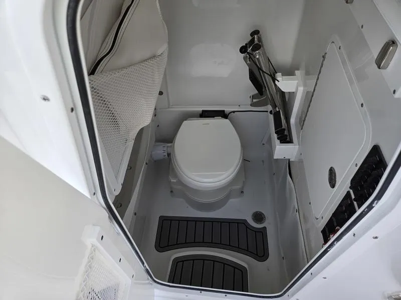 Slide: The Image of 2026 Sea Hunt Ultra 275se boat interior with compact marine toilet. - 14