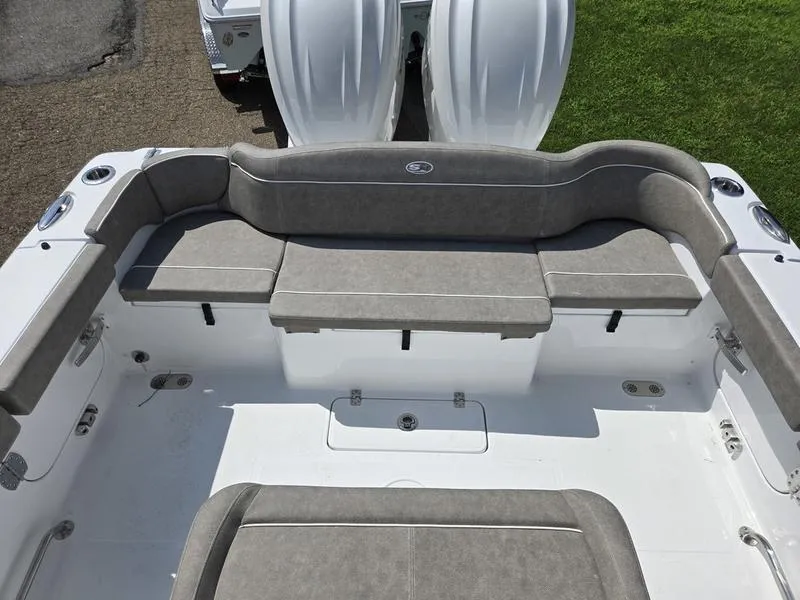 Slide: The Image of 2026 Sea Hunt Ultra 275se boat interior with gray cushioned seating. - 3
