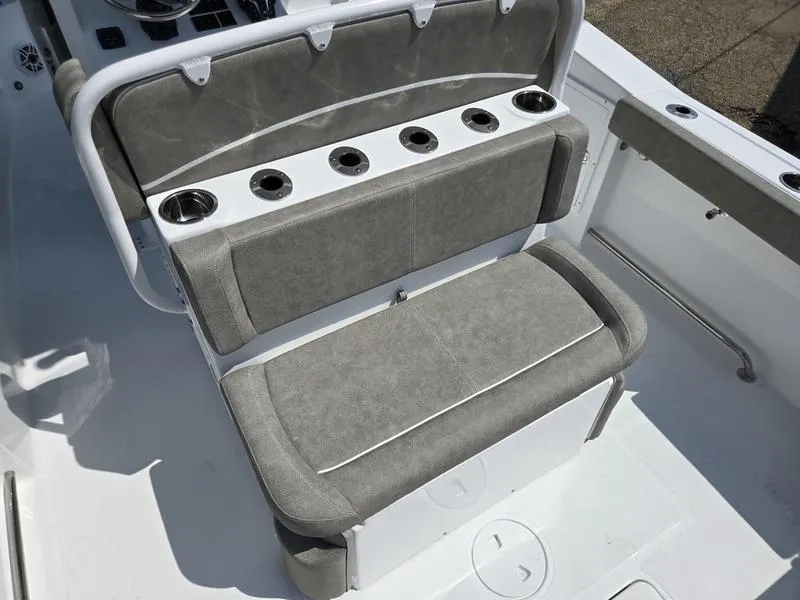 Slide: The Image of 2026 Sea Hunt Ultra 275se boat seating with cup holders and gray upholstery. - 6