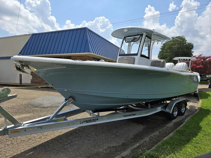 Slide: The Image of 2026 Sea Hunt Ultra 275se boat on trailer, parked outdoors under a cloudy sky. - 7