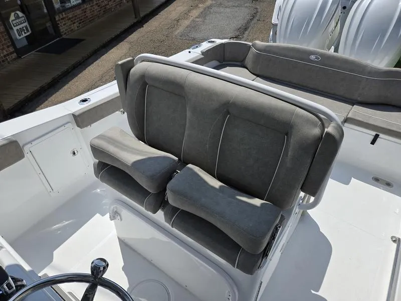Slide: The Image of 2026 Sea Hunt Ultra 275se boat interior with gray cushioned seating. - 9