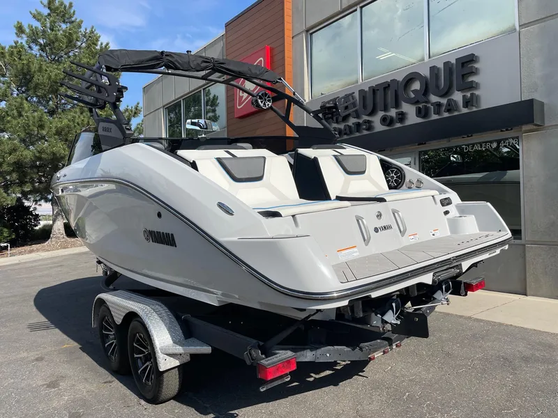 Slide: The Image of 2023 Yamaha Boats 222XD on trailer outside dealership, showcasing sleek design and modern features. - 3
