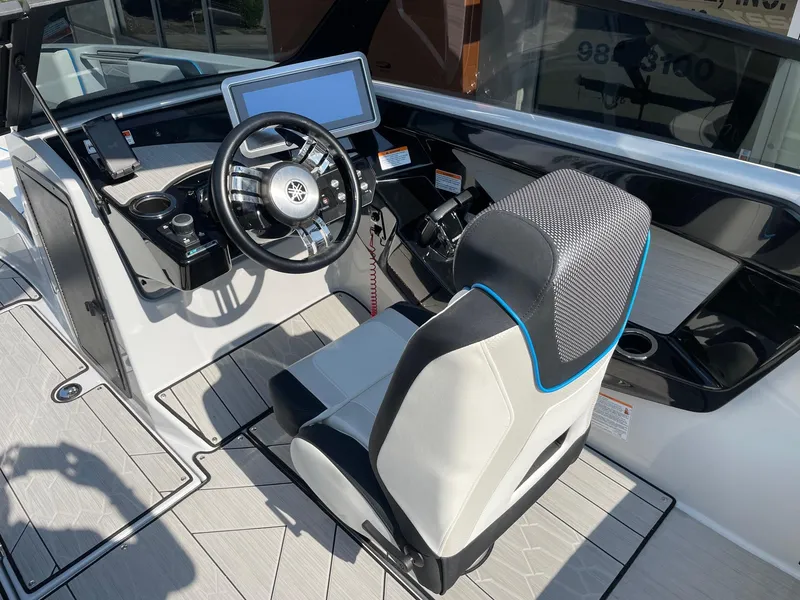 Slide: The Image of 2023 Yamaha Boats 222XD cockpit with steering wheel and modern dashboard. - 6
