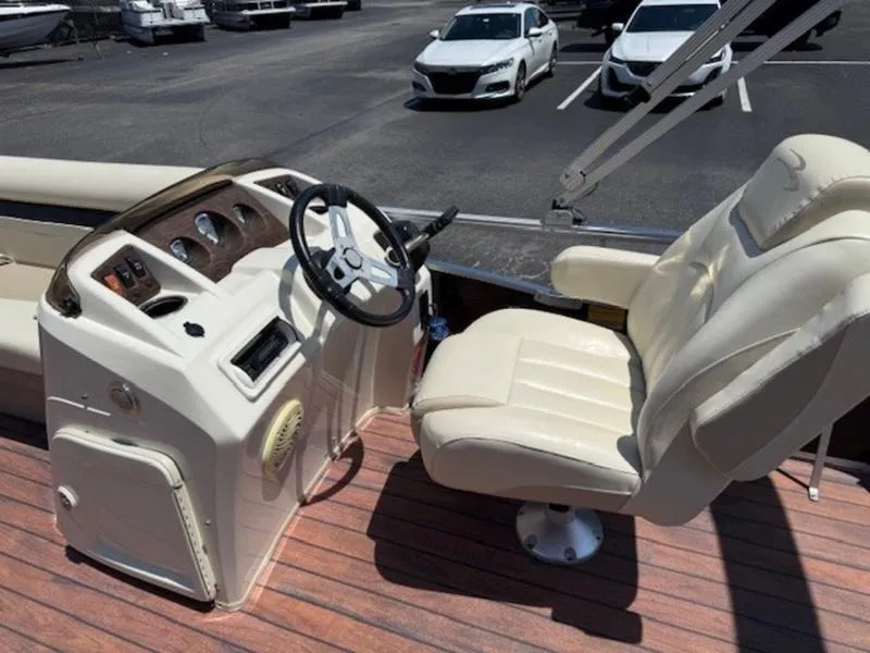 Slide: The Image of 2014 Bennington 22 SLX boat interior with steering wheel and captain's chair. - 14