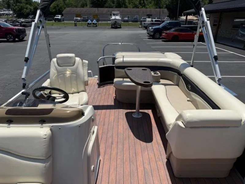 Slide: The Image of 2014 Bennington 22 SLX pontoon boat interior with beige seating and wood-style flooring. - 15