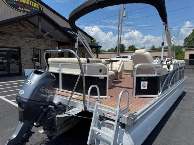 Slide: The Image of 2014 Bennington 22 SLX pontoon boat with Yamaha 50 engine, parked outside a marine shop. - 3