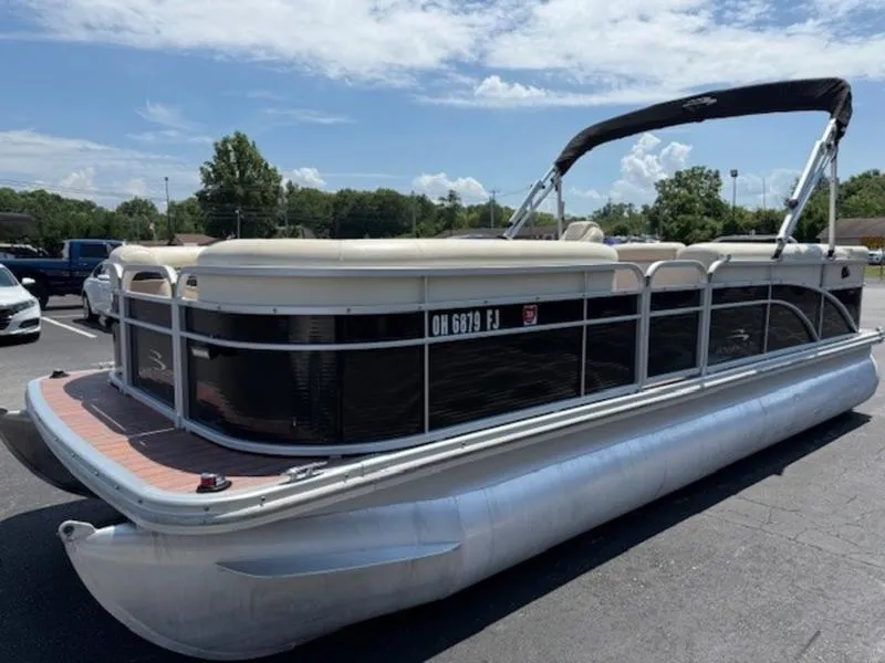 Slide: The Image of 2014 Bennington 22 SLX pontoon boat parked outdoors on a sunny day. - 4
