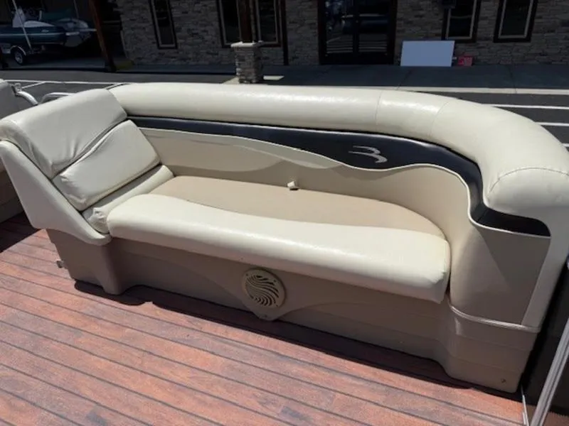 Slide: The Image of 2014 Bennington 22 SLX boat seating with beige upholstery and wood-style flooring. - 8