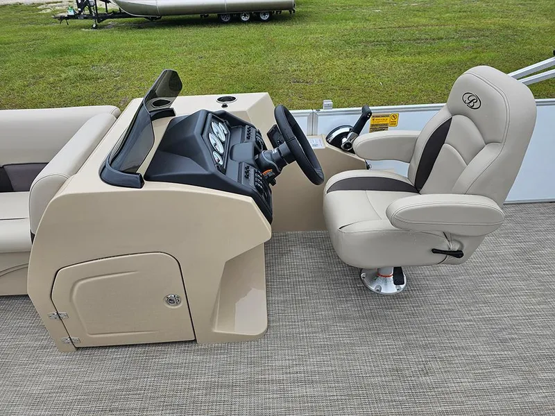 Slide: The Image of 2026 Bentley Pontoons Legacy 243 Cruise helm with beige captain's chair and control panel. - 14