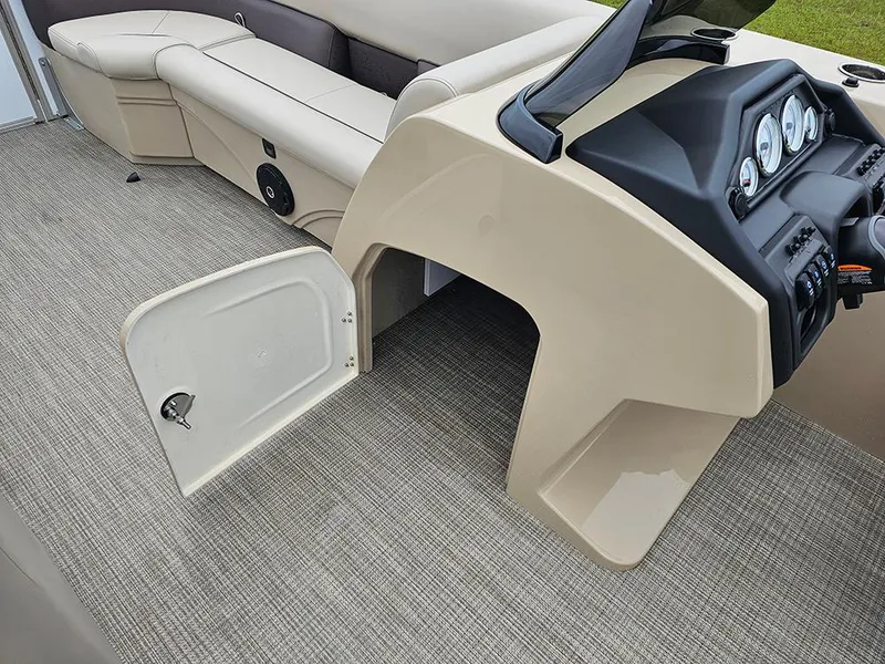 Slide: The Image of 2026 Bentley Pontoons Legacy 243 Cruise interior with open storage compartment and dashboard. - 19