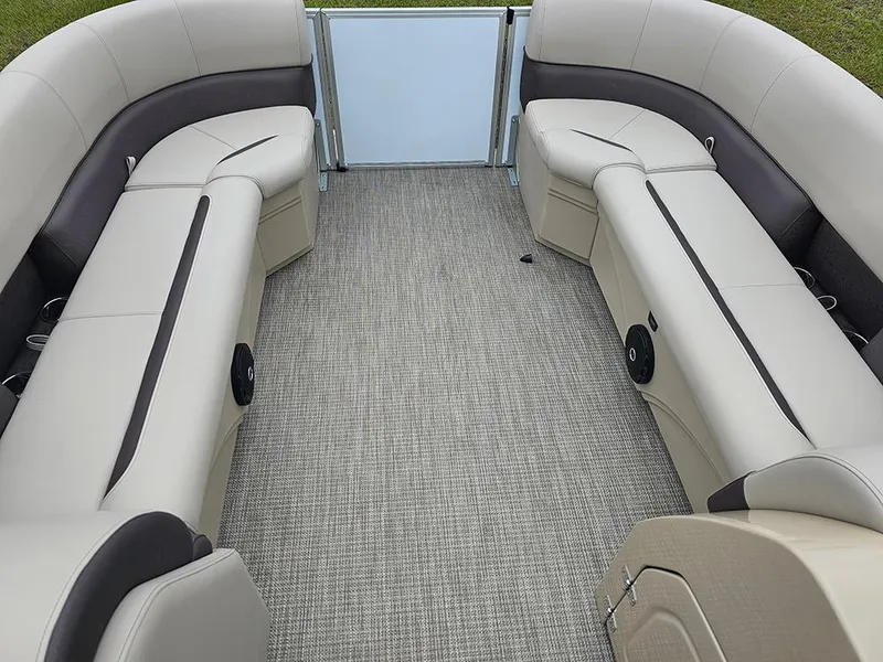Slide: The Image of 2026 Bentley Pontoons Legacy 243 Cruise interior with beige seating and carpeted floor. - 20