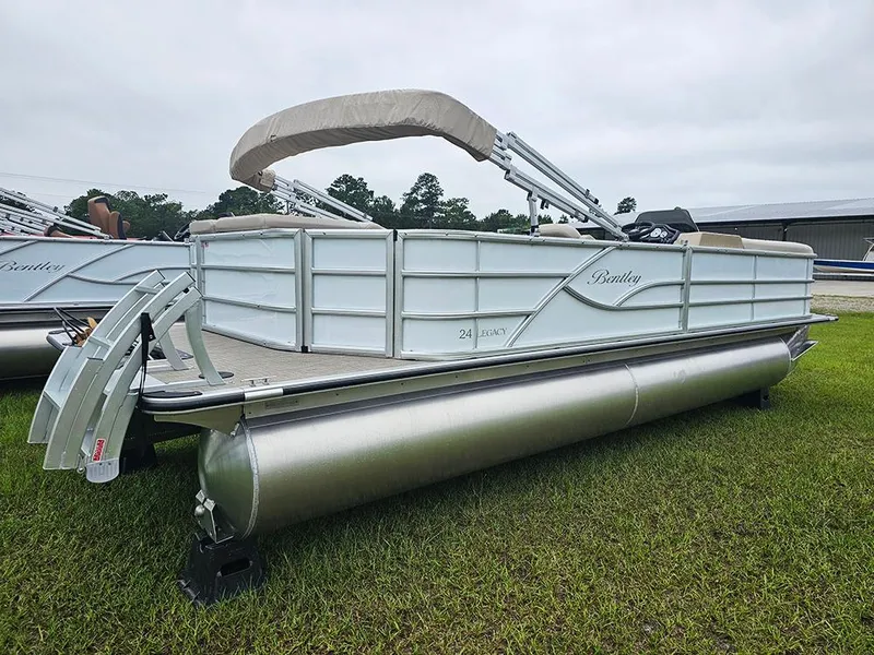 Slide: The Image of 2026 Bentley Pontoons Legacy 243 Cruise on grass, featuring sleek design and canopy. - 3