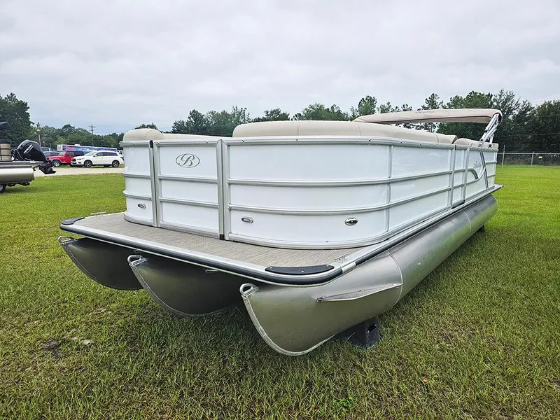 Slide: The Image of 2026 Bentley Pontoons Legacy 243 Cruise on grass, showcasing sleek design and spacious deck. - 5