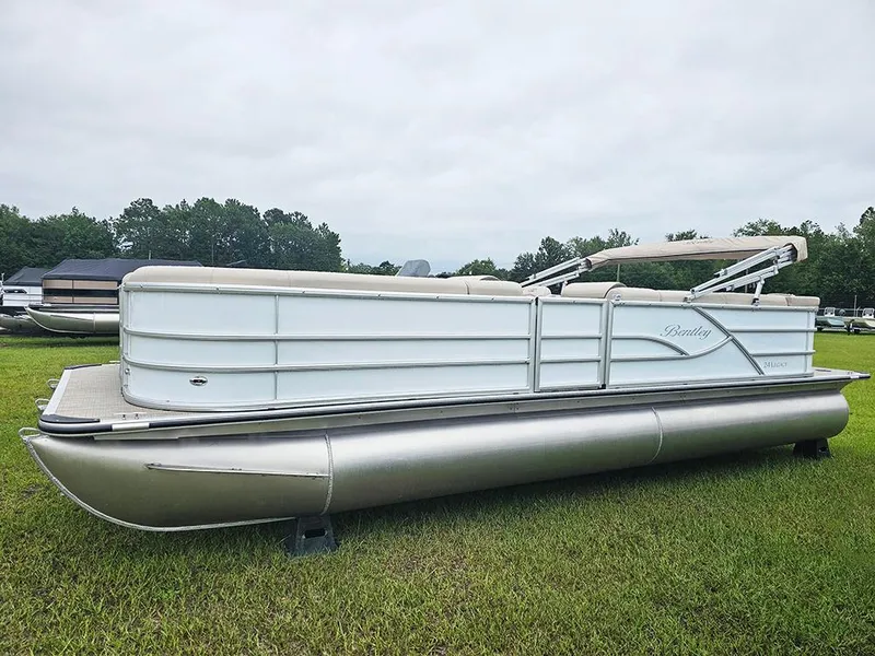 Slide: The Image of 2026 Bentley Pontoons Legacy 243 Cruise on grass, showcasing sleek design and luxury features. - 6