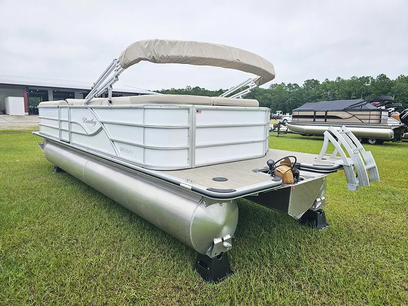 Slide: The Image of 2026 Bentley Pontoons Legacy 243 Cruise on grass, showcasing sleek design and spacious deck. - 7