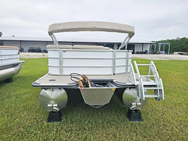 Slide: The Image of 2026 Bentley Pontoons Legacy 243 Cruise on grass, rear view with ladder and canopy. - 8