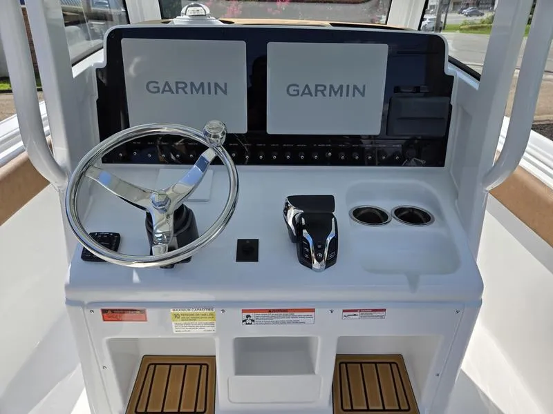 Slide: The Image of 2026 Sea Hunt Ultra 255se helm with dual Garmin displays and steering wheel. - 10