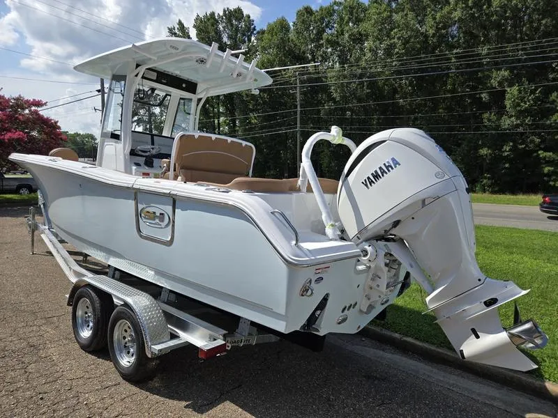 Slide: The Image of 2026 Sea Hunt Ultra 255se boat with Yamaha engine on a trailer, parked outdoors. - 11