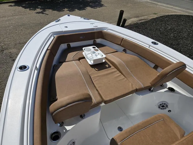 Slide: The Image of 2026 Sea Hunt Ultra 255se boat interior with tan seating and cup holders. - 12
