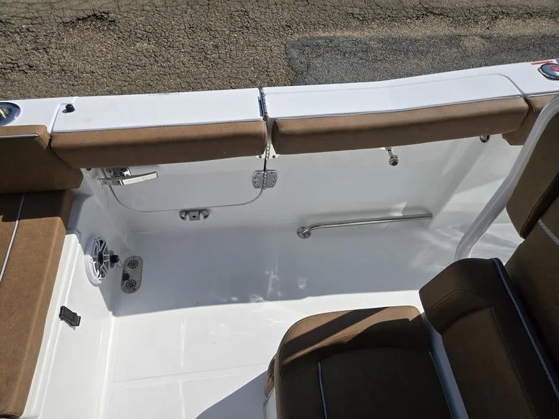 Slide: The Image of 2026 Sea Hunt Ultra 255se boat interior with brown seating and white deck. - 13
