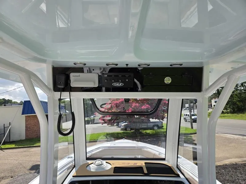 Slide: The Image of Interior view of 2026 Sea Hunt Ultra 255se boat, featuring control panel and windows. - 14