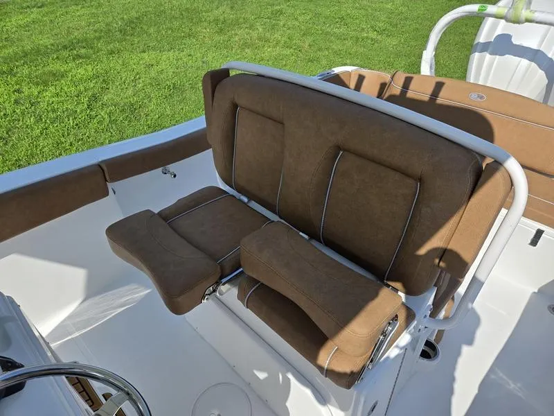 Slide: The Image of 2026 Sea Hunt Ultra 255se boat with brown cushioned seating on deck. - 5