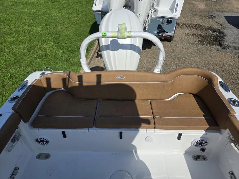 Slide: The Image of 2026 Sea Hunt Ultra 255se boat interior with brown seating and white accents. - 7