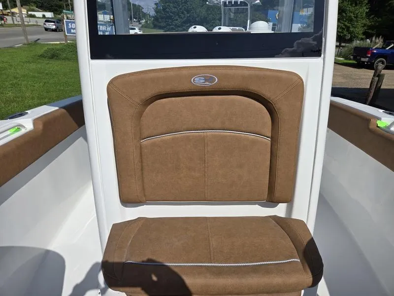 Slide: The Image of 2026 Sea Hunt Ultra 255se boat with brown cushioned seating. - 8